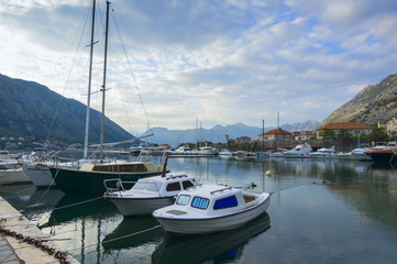 Fototapeta na wymiar Evening landscape with moored boats in Kotor Bay, Montenegro