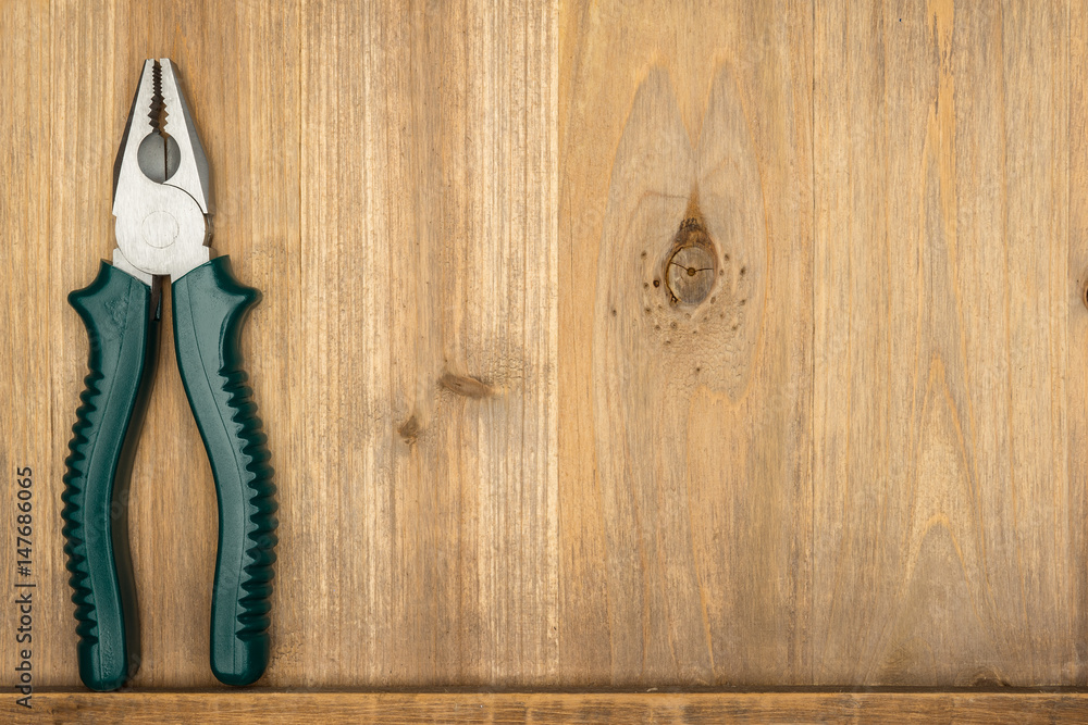 Wall mural Top view of different type of constructive tools with copy space on wooden background. Construction instruments and car tools. Home tool kit. Everyday instruments. Work stuff. Mend and repair.