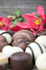 Delicious chocolate candies on wooden background
