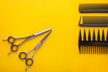 Hairdresser set with various accessories on yellow background