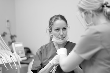 The doctor performs medical manipulations in the treatment of a patient in a dental clinic