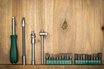 Top view of different type of constructive tools with copy space on wooden background. Construction instruments and car tools. Home tool kit. Everyday instruments. Work stuff. Mend and repair.