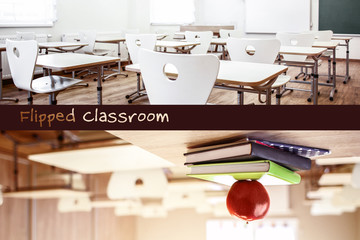 School teacher's desk with stack of books and apple