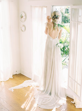Rear view of a bride standing in her wedding dress