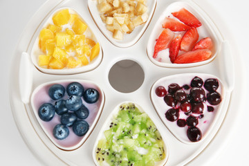 Automatic yogurt maker with fruits, closeup