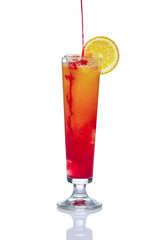 Orange alcohol cocktail with strawberry. Pouring berry liqueur. Isolated on white background