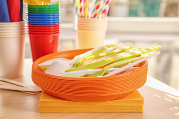 Colorful plastic ware for picnic on table