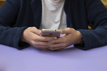 close-up of hands of the child with the mobile phone