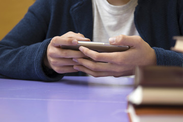 close-up of hands of the child with the mobile phone