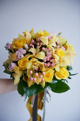 Fresh yellow bouquet of yellow roses and pink berries. Bright colors