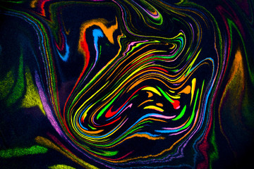 Colorful abstract acrylic painting. Natural dynamic mixture of oil colored pigments fluid flow on black background. Naturally blurred.