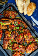 Roasted sliced barbecue pork ribs, seasoned with a spicy basting sauce and served with vegetables.