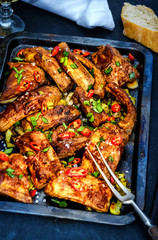 Roasted sliced barbecue pork ribs seasoned with a spicy basting sauce on the baking tray