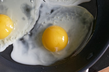 Fried eggs from a hen's egg in a frying pan with yellow yolk
