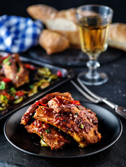 Roasted sliced barbecue pork ribs, seasoned with a spicy basting sauce and served with vegetables.