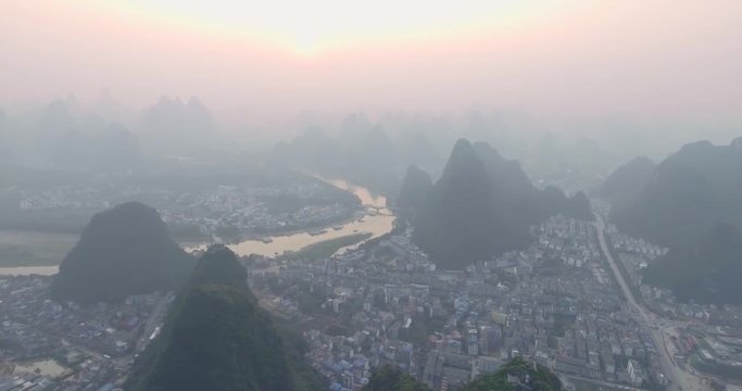 Top view of amaizing famous Yangshuo valley in Guilin, Guangxi, China. Aerial View of beautiful sunrise over Yulong or Dragon River in Yangshuo, China. Overpopulation concept, beauty in nature