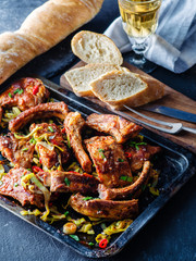 Roasted sliced barbecue pork ribs, seasoned with a spicy basting sauce and served with vegetables.