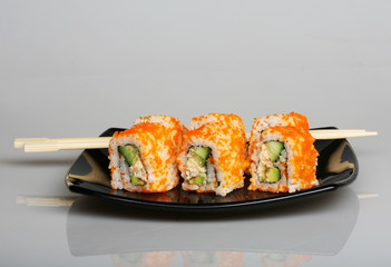 japanese  rolls on black plate.