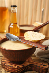 Delicious cream soup with bread on table