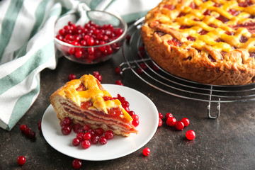 Plate with slice of homemade berry pie on table
