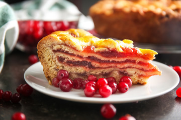 Plate with slice of homemade berry pie on table