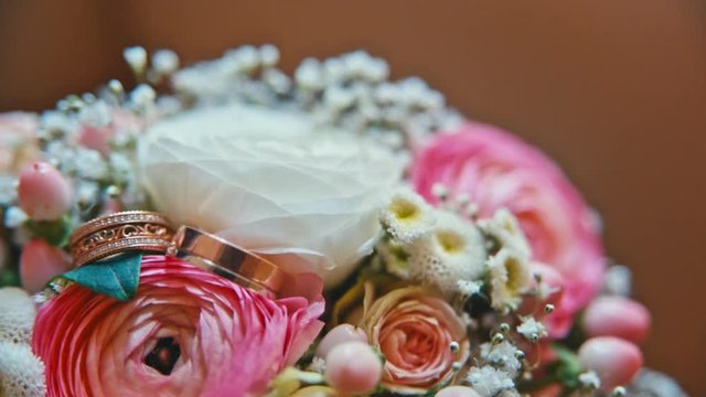 Rings lie on the Bridal bouquet.