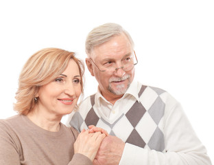 Happy senior couple holding hands isolated on white