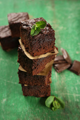 Pieces of delicious chocolate cake on wooden background