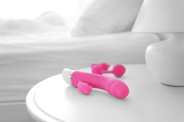 Vibrator and anal balls on bedside table