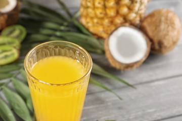 Glass of pineapple juice on wooden table