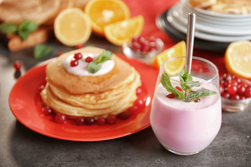 Glass with yogurt on dark table