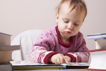 beautiful little child girl learns to read (success, education,  development)