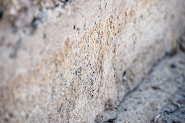 Wall of destruction of concrete structure, stones.
