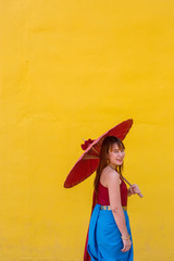 Fototapeta premium girl in thai dress costume with umbrella
