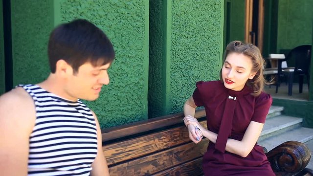 A man and a girl in retro style talk to each other at a distance