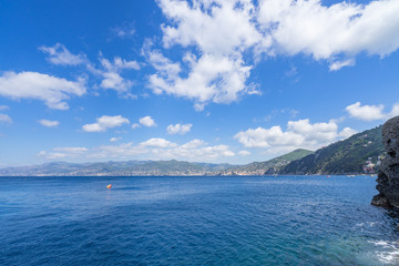 Beautiful blue sea waters and cloudy sky over Tigullio, near Camogli, Liguria, Italy