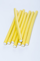 Yellow hair curlers on white