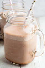 Cocoa in glass mugs close-up on white background.
