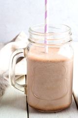 Cocoa in a glass mug on a white background.