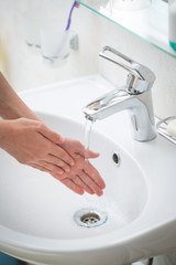 The boy is washing his hands