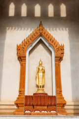 Golden standing buddha statue.
