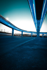 Empty road floor with city viaduct bridge of neon lights night