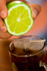 Delightful cup of tea with some drops of lemon, home antimicrobial therapy