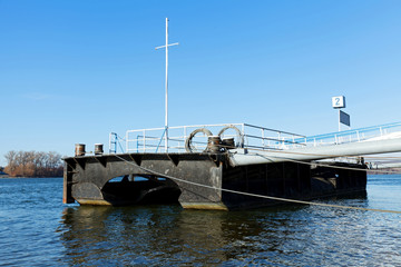 Dock on the river in winter sunlight