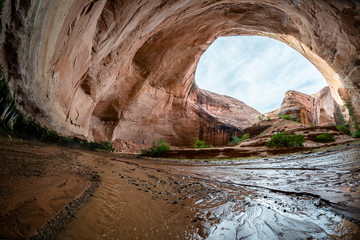 Large desert cave with flowing stream wide angle