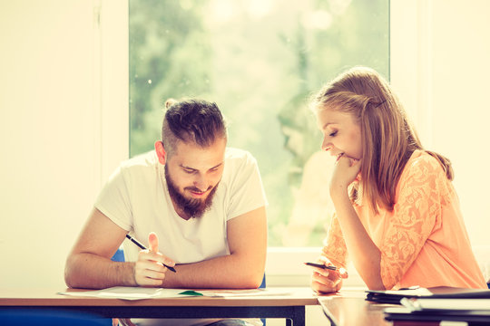 Two Students Talking In Classroom