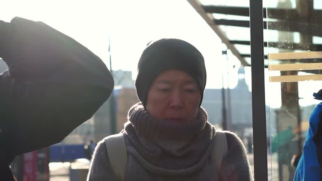 Asian senior with family travel to Amsterdam and using tram for transport around the city slow motion 120fps