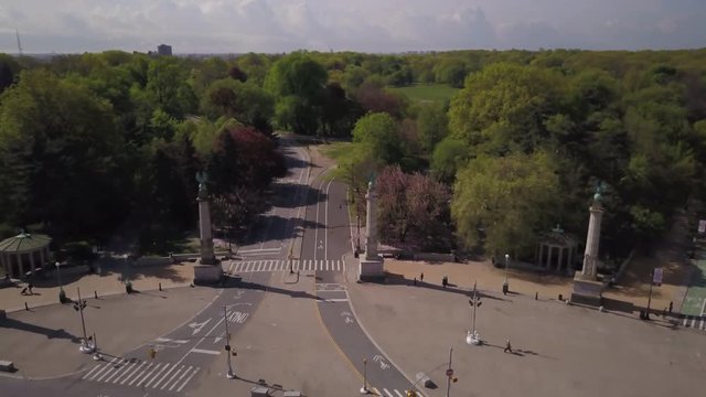 pulling back from a view of Prospect Park Brooklyn to reveal the arch in Grand Army Plaza