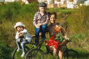 happy mother during a summer walk with the kids on the bike
