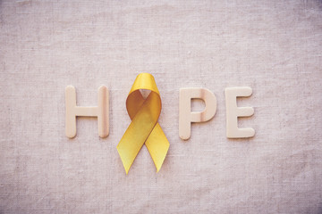 yellow gold ribbon with HOPE letters, Sarcoma Awareness, Bone cancer, Liver cancer, Bladder Cancer,...